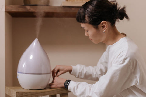 Woman adjusting a diffuser